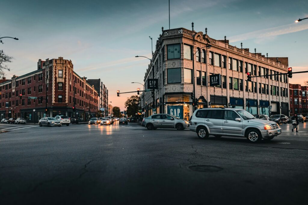 Busy city traffic among tall buildings, highlighting expert urban moving logistics and navigation.