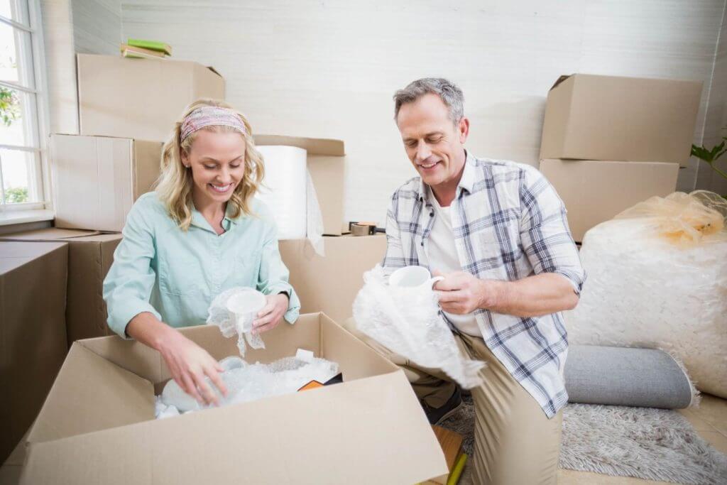A man and a woman packaging their belongings