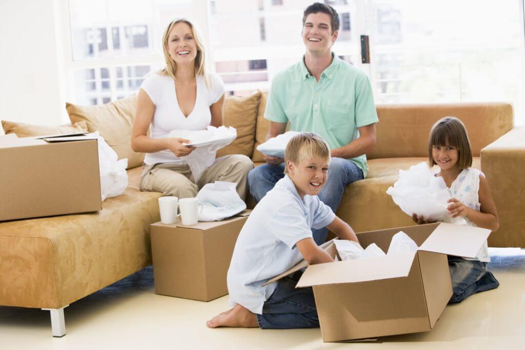 A family packaging their home for a move, and everyone’s holding a dish