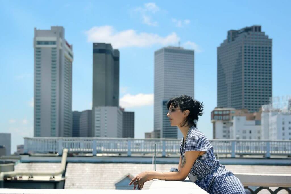 A girl in a dress on the top of a building