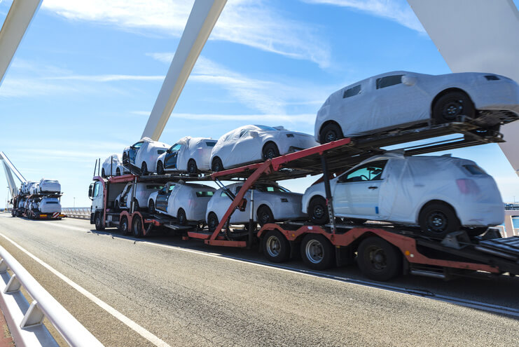 A truck carrying cars