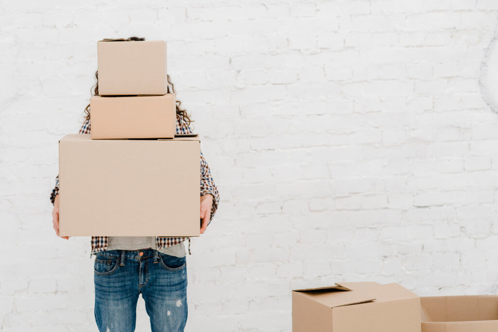 A person holding three boxes for long-distance moving