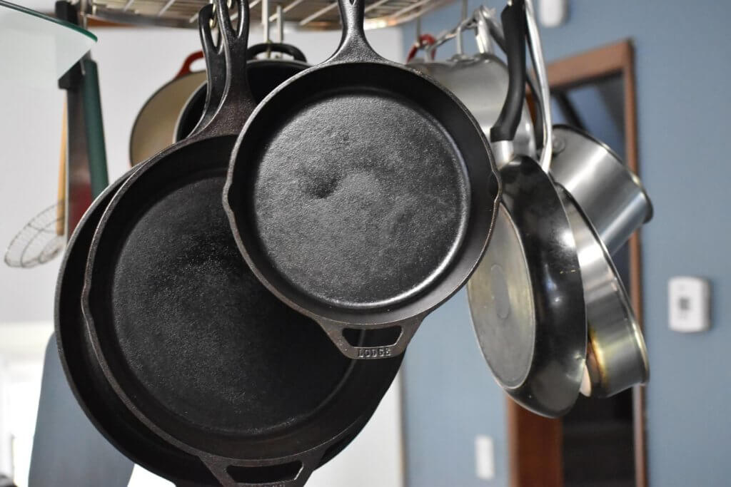 Frying cookware hanging from hooks