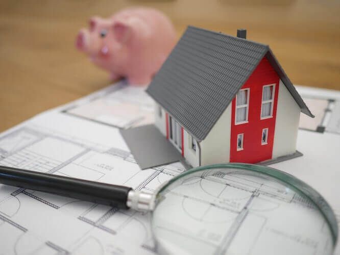 House blueprints and a piggy bank