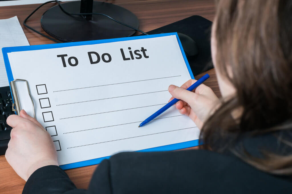 A man creating a long-distance moving to-do list