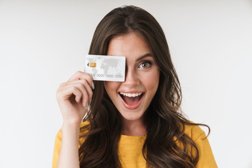 A girl holding a credit card