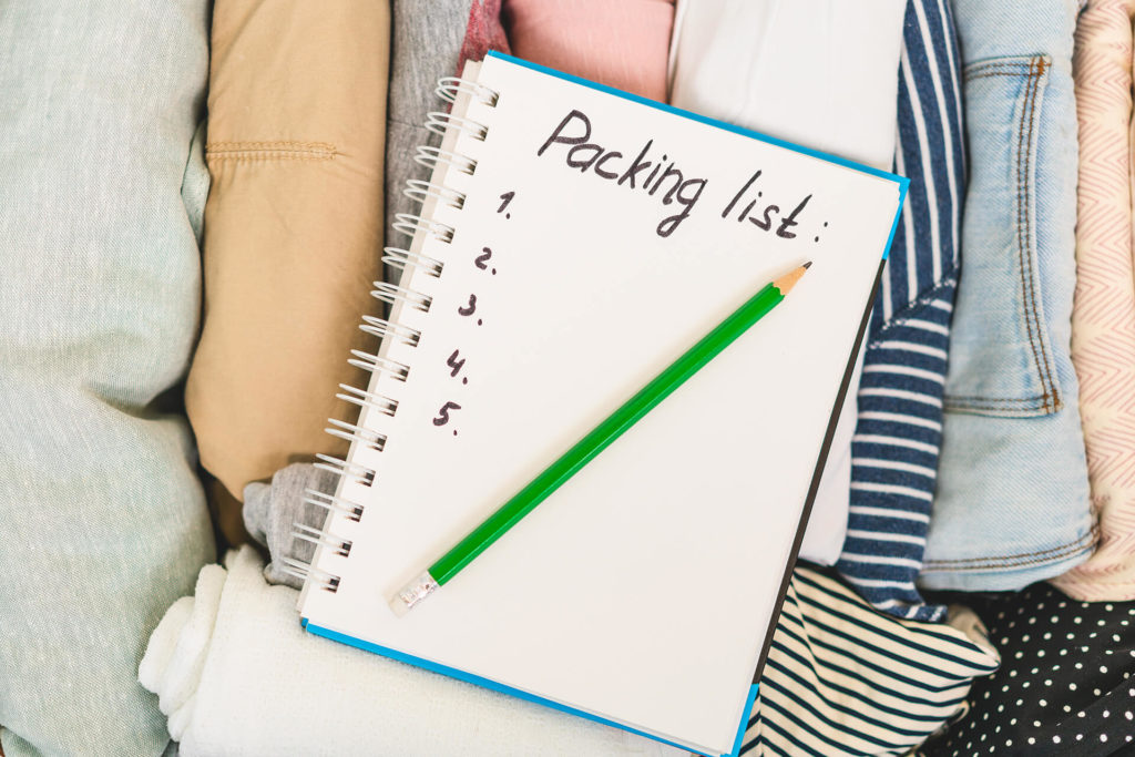 A person writing a packing list