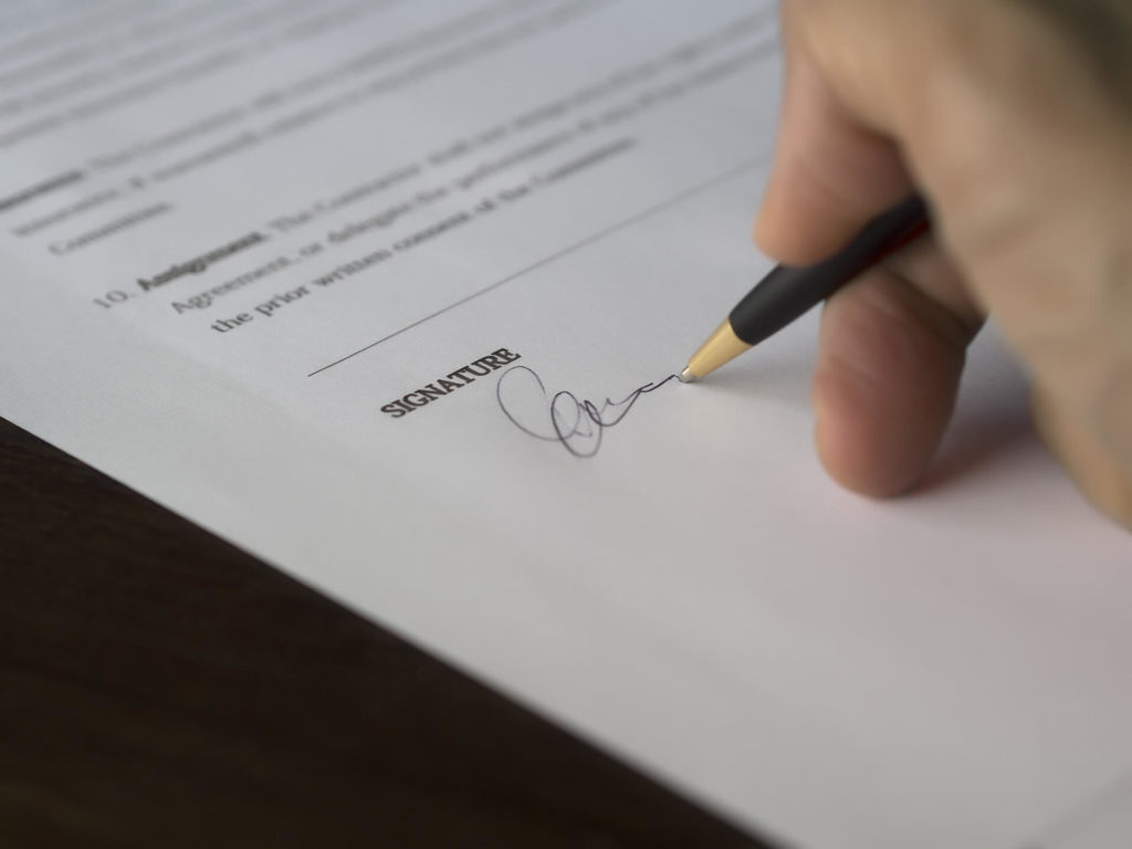 A man signing a document