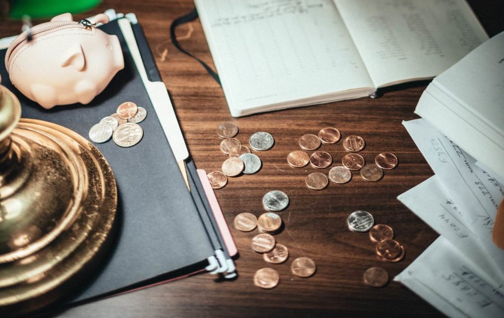 Coins on the desk with some papers for long-distance moving services