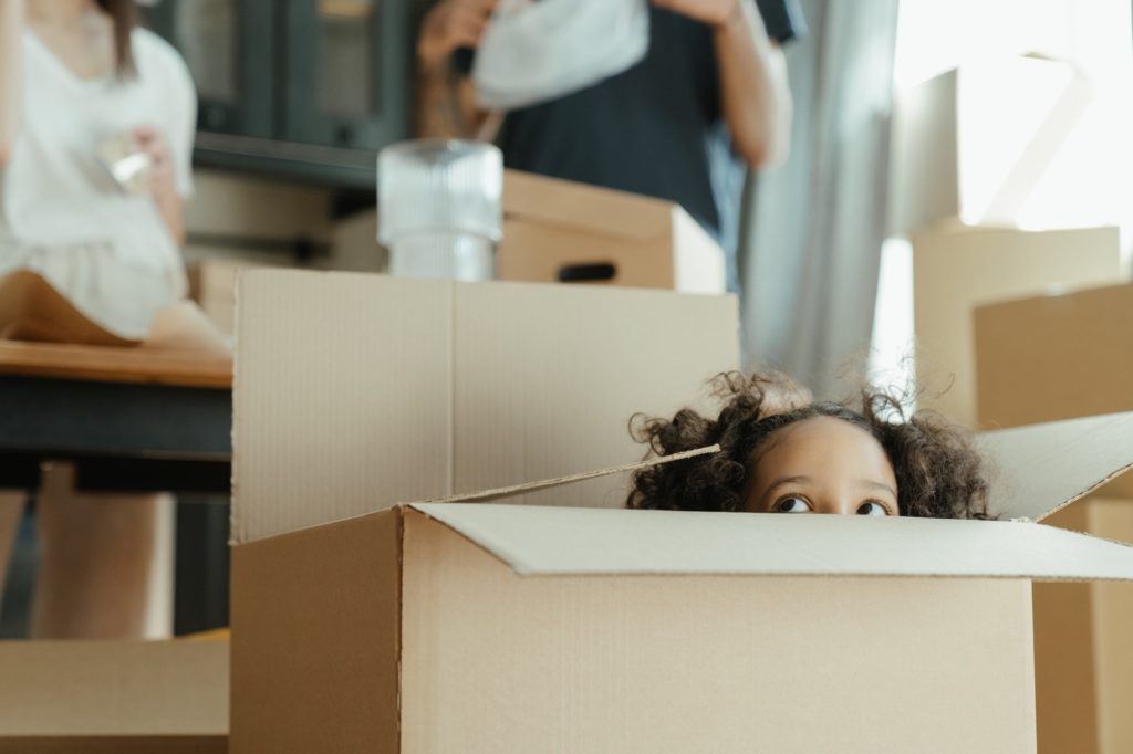 A child peeking out of a box