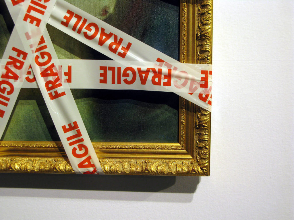 A painting wrapped with fragile printed tape