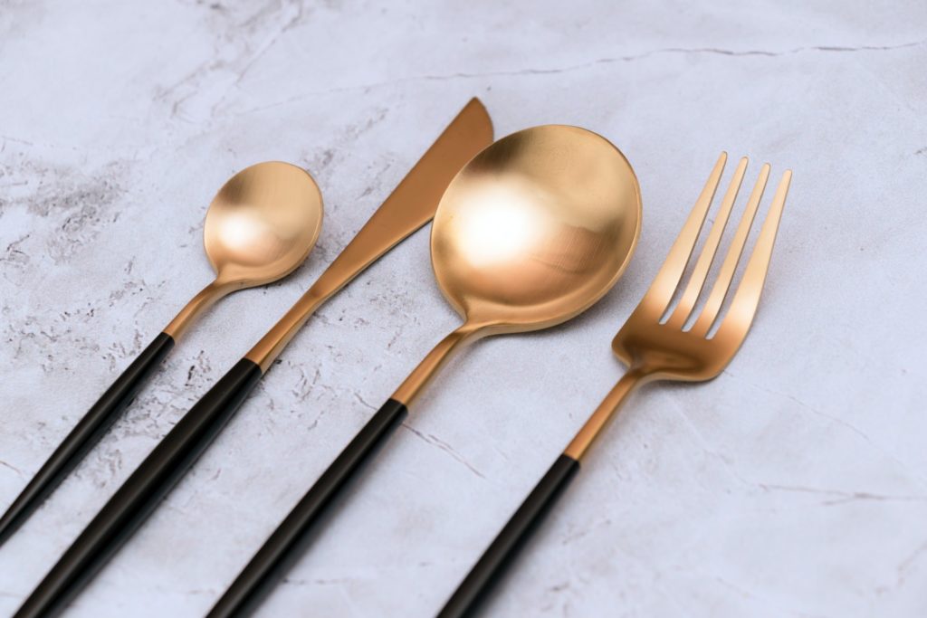 Black and gold cutlery on the table ready for cross-country moving