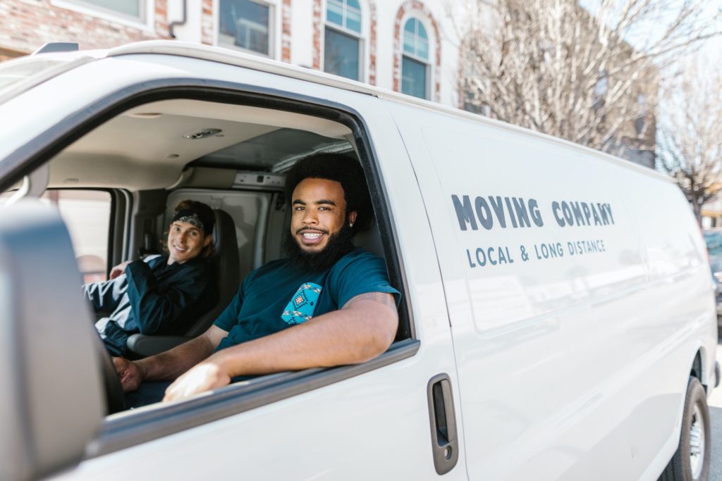 Professional movers in a white minivan ready to help with local or long-distance moving