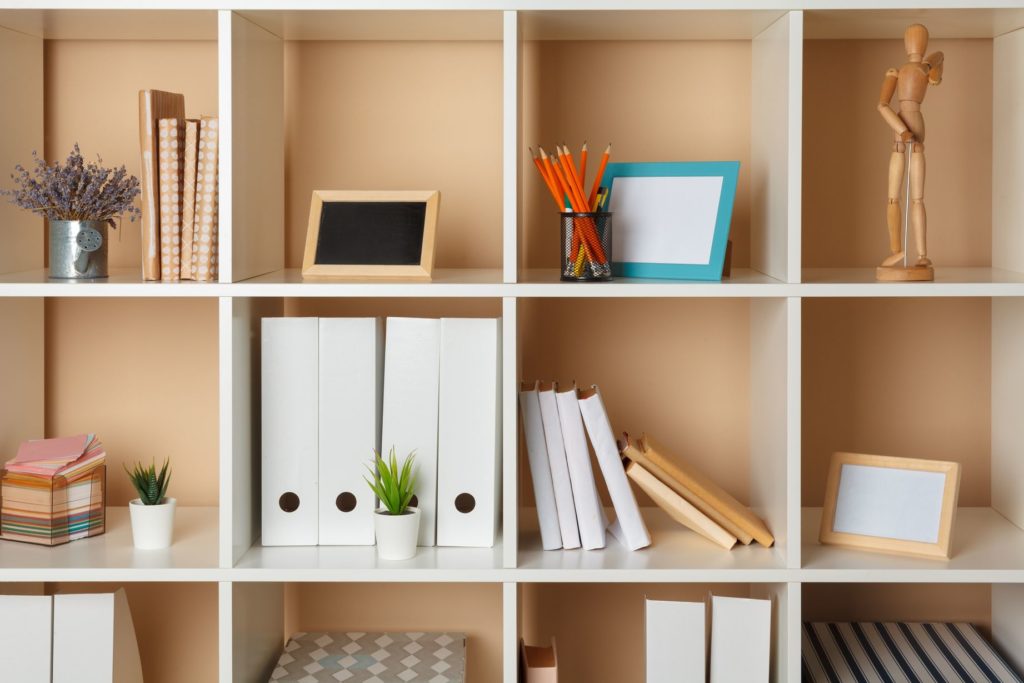 a shelf with a bunch of decor and file organizers