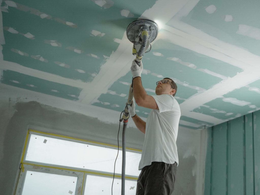 Man polishing the ceiling before long-distance moving