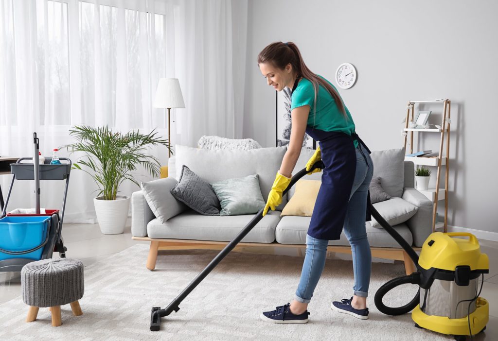 A professional cleaner vacuuming