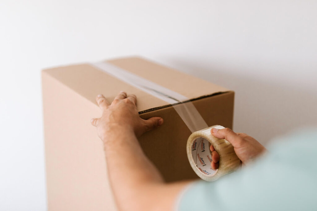 A woman taping the box