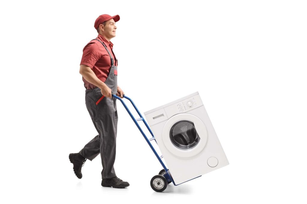 Professional mover carrying a washing machine on a dolly