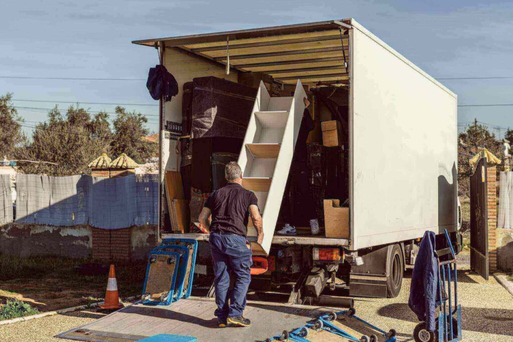 Long-distance movers loading furniture into the truck