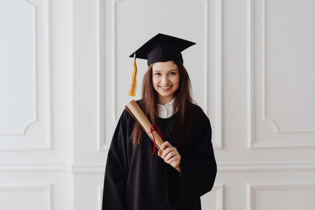 A woman smiling in a graduation toga 