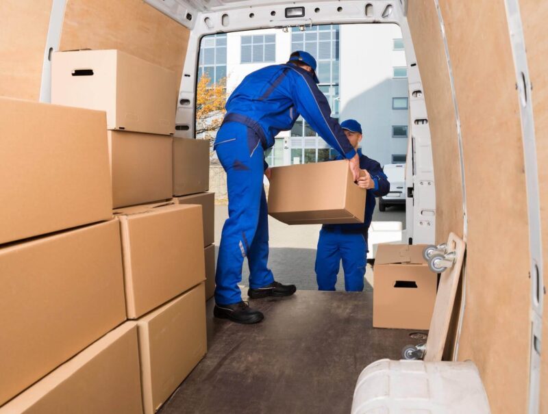 Long distance movers in a relocation truck handling boxes