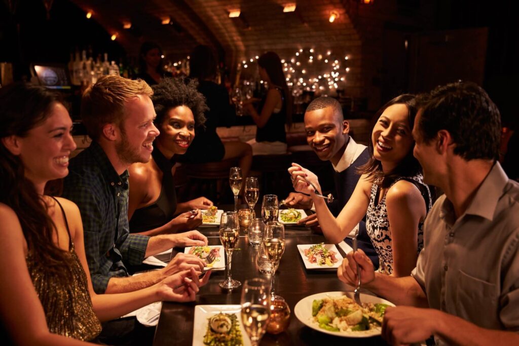 People having fun in a restaurant after long-distance moving