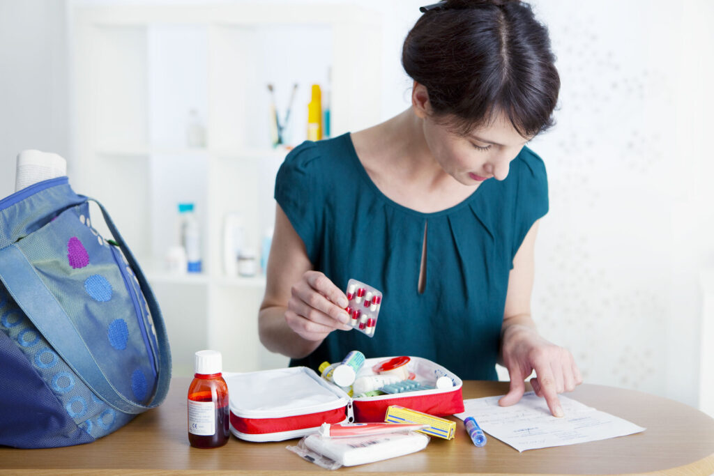 A woman packing medications for a move