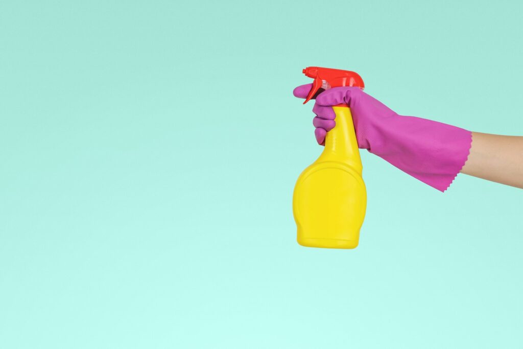 A spray bottle and gloves