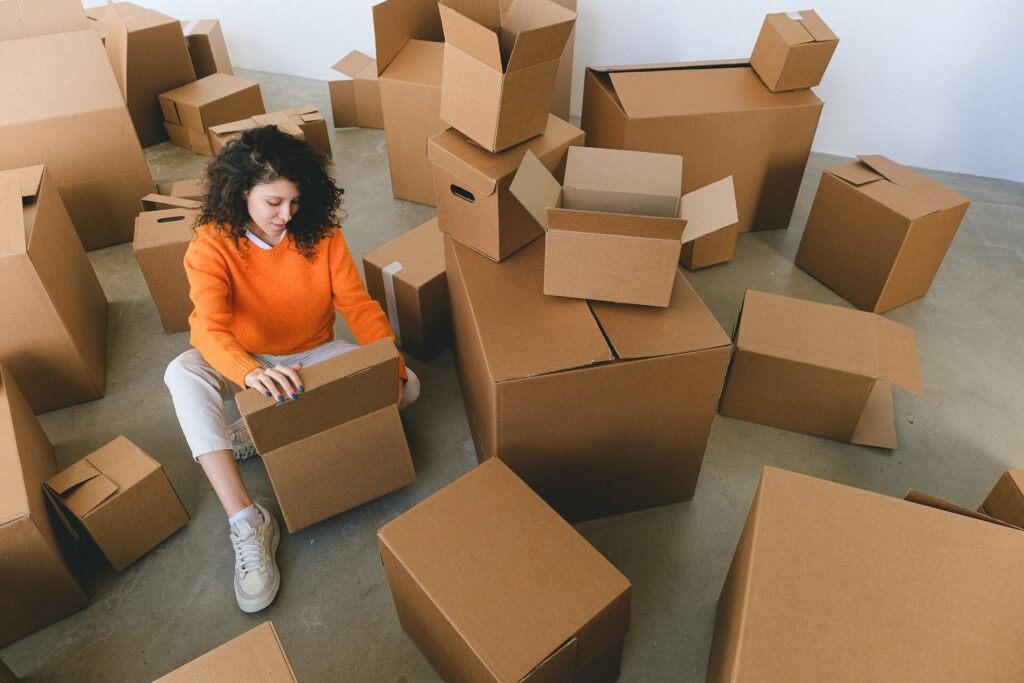 Girl on the floor surrounded by boxes