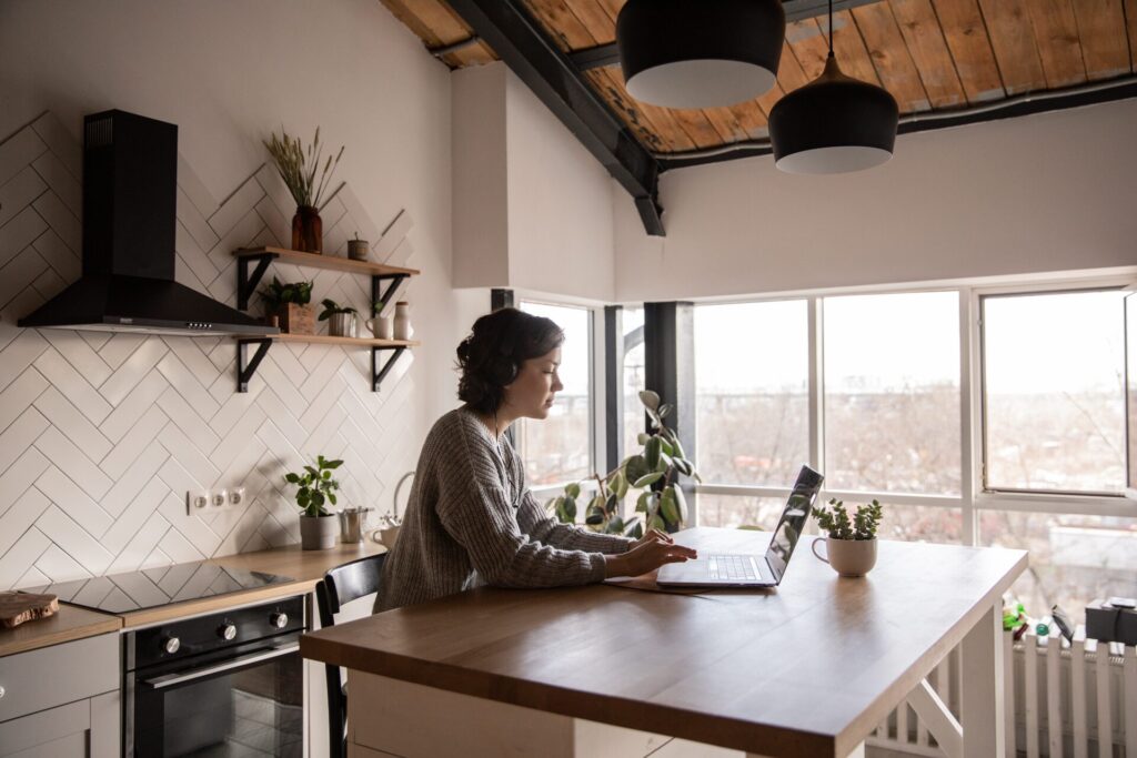 A woman using a laptop in the kitchen