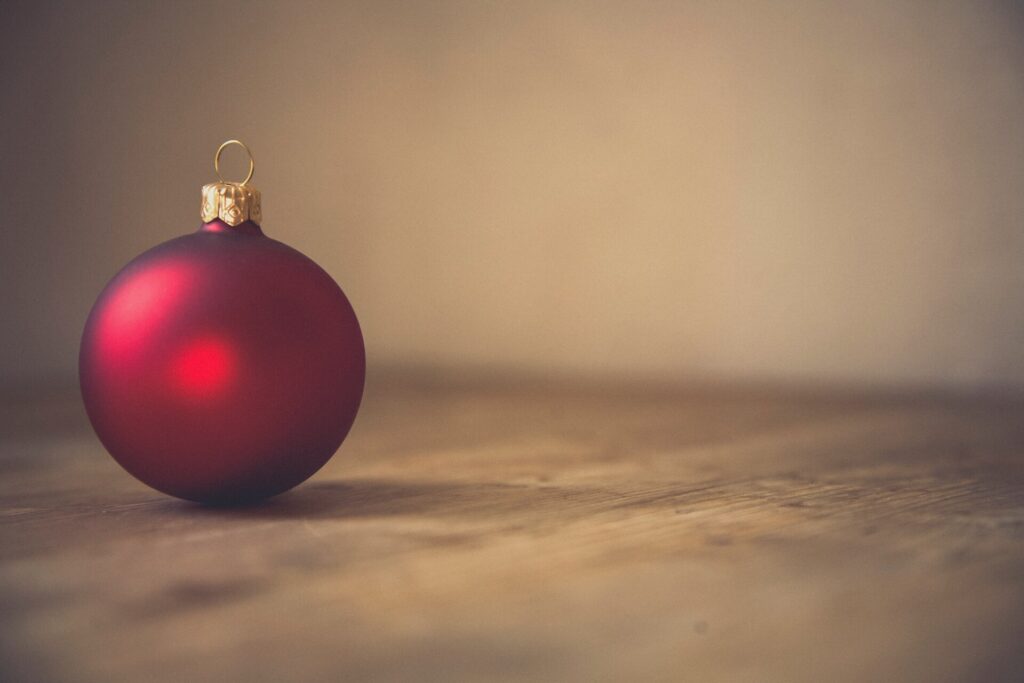 photo of red ball ornament on surface