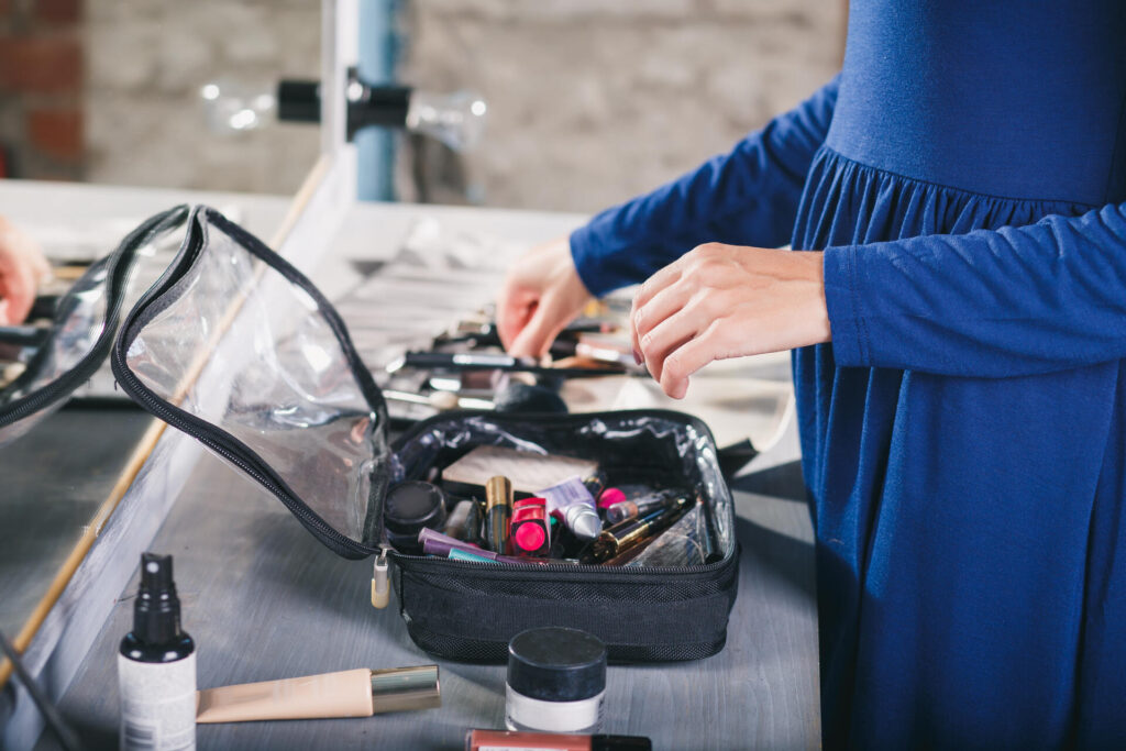 A woman packing a make-up bag