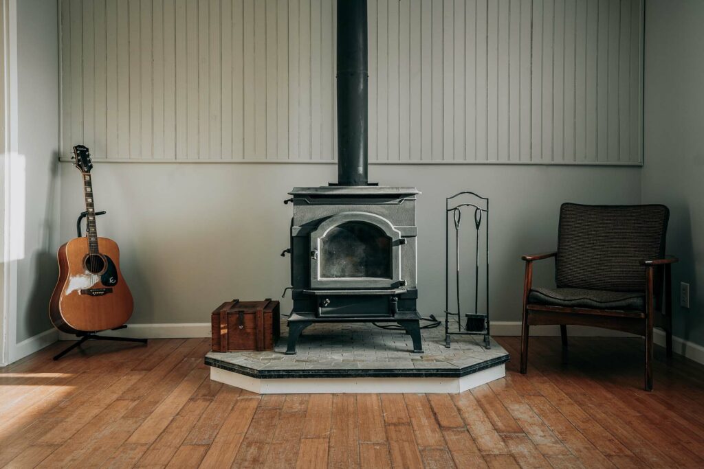 Wood stove, acoustic guitar, and chair