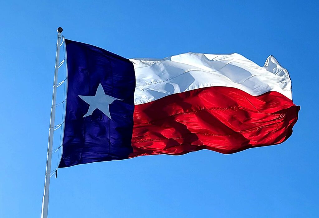 The Texas flag on a clear, windy day