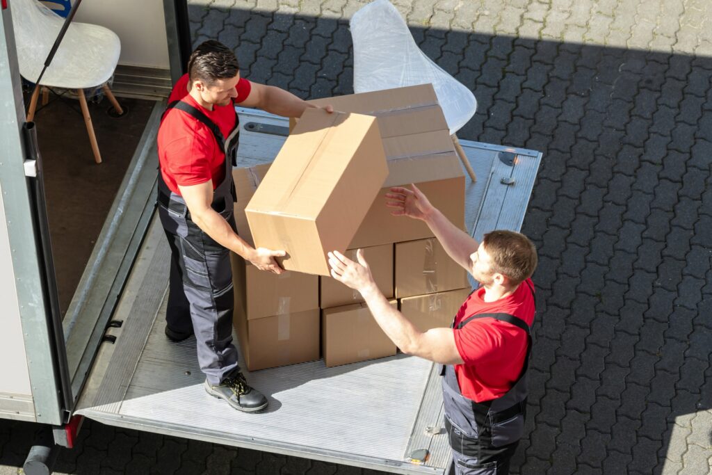 Licensed movers loading a branded truck in New York City