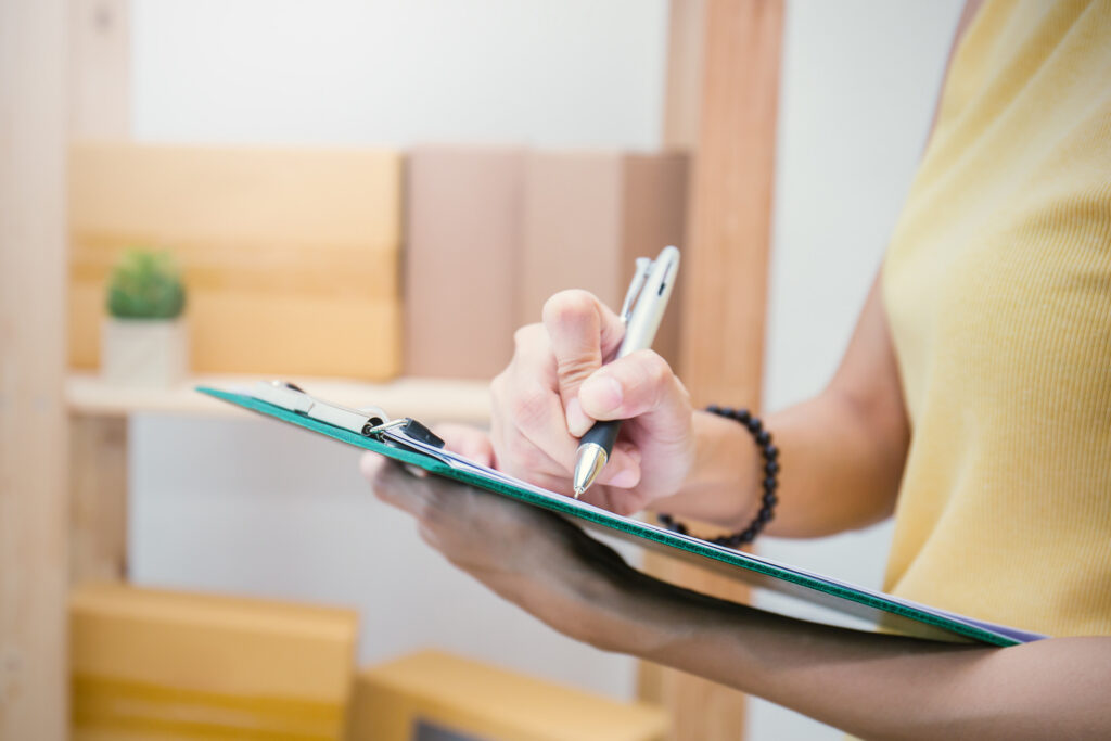 Person writing a checklist